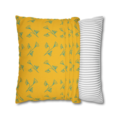 Yellow pillow with green leaf pattern and gray and white striped pillow on white background