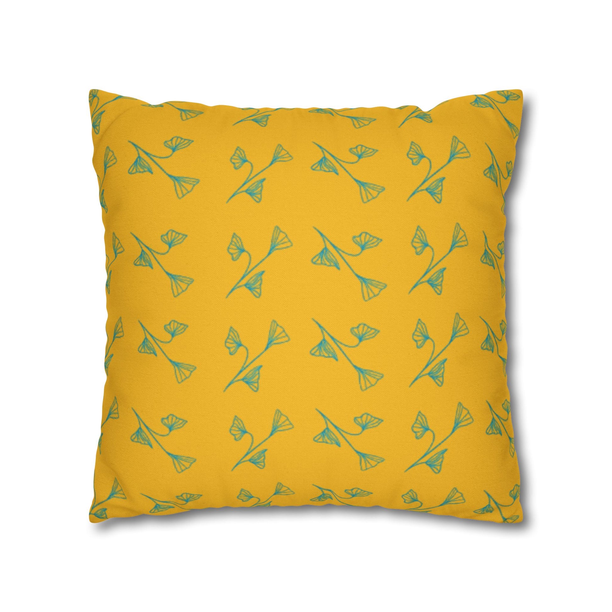 Yellow pillow with green floral pattern on a white background