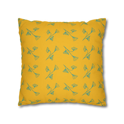 Yellow pillow with green floral pattern on a white background