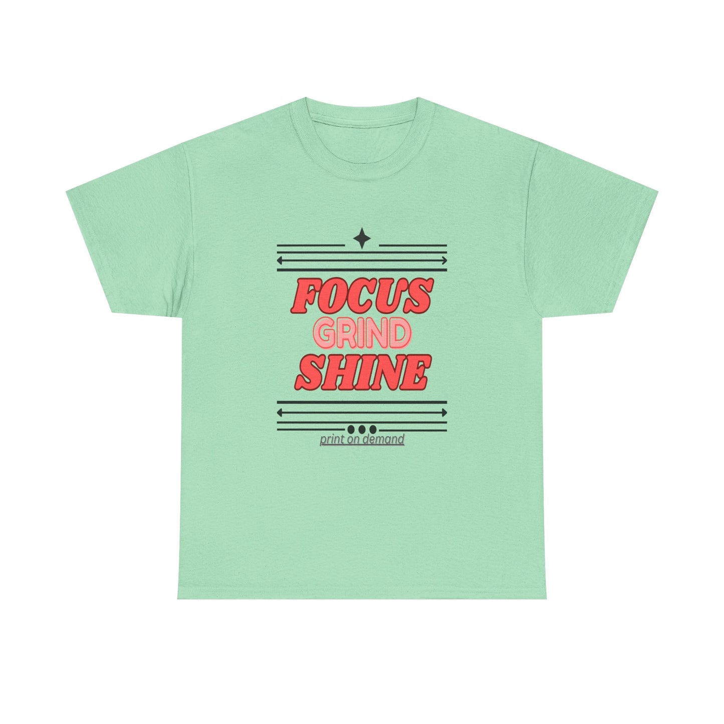 A  mint green unisex heavy cotton tee with the text 'FOCUS GRIND SHINE' printed on the front.