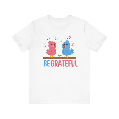 T-shirt with “Be Grateful” text and two bird illustrations – inspirational and nature-themed design for everyday wear.