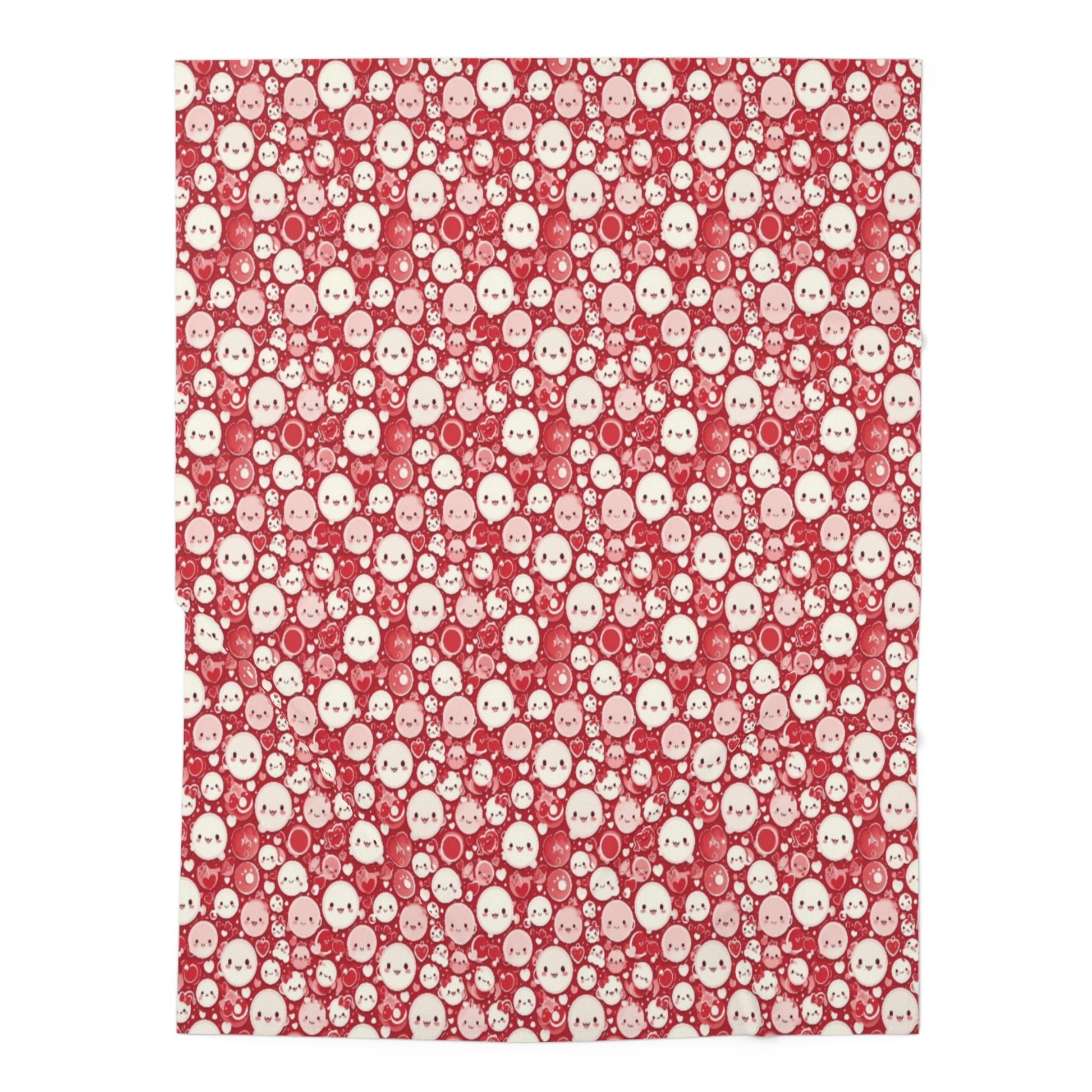A red and white baby swaddle blanket with a pattern of cute faces.