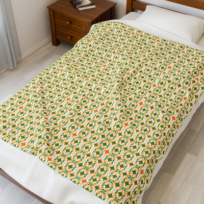 Bed with a patterned blanket in a room with a wooden nightstand.