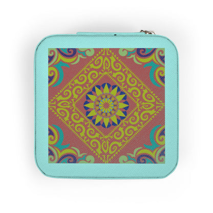 Hand holding a small square travel jewelry case with a colorful pattern on a white background