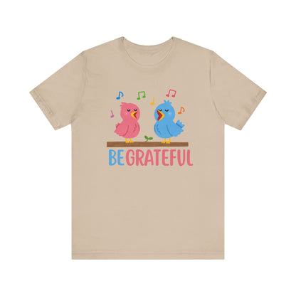 T-shirt with “Be Grateful” text and two bird illustrations – inspirational and nature-themed design for everyday wear.