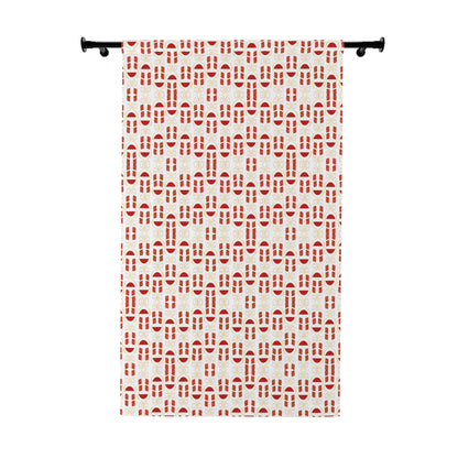 Red and white geometric pattern curtain hanging on window in a modern room

