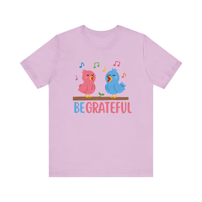 T-shirt with “Be Grateful” text and two bird illustrations – inspirational and nature-themed design for everyday wear.