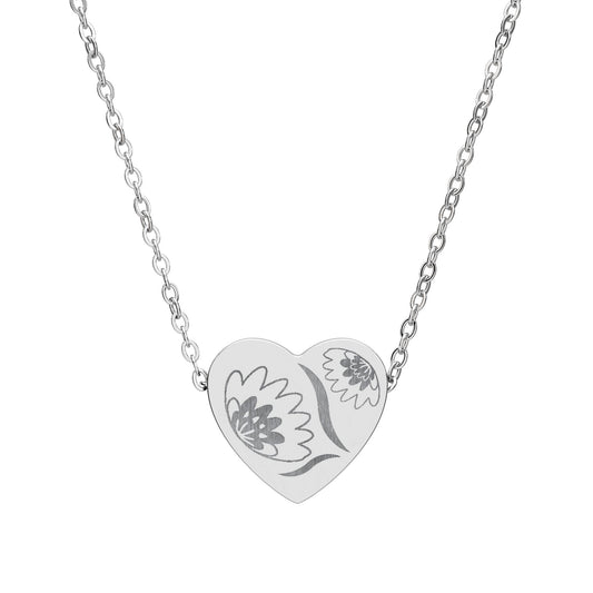 Silver heart-shaped necklace with floral design on a white background