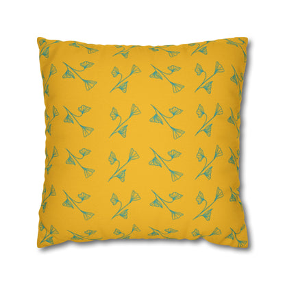 A square-shaped yellow pillowcase with a green leaf pattern.