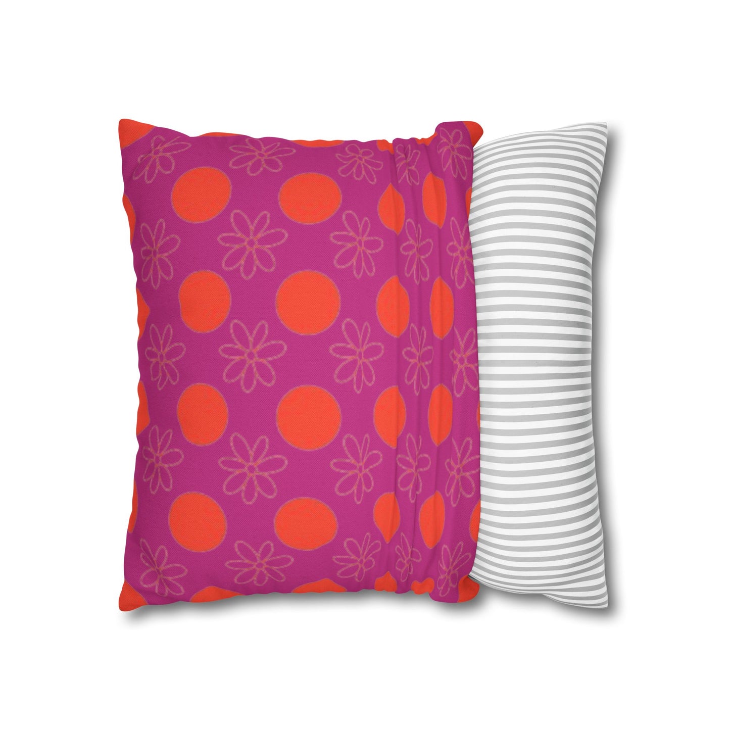 pillow with patterned covers, one pink with red circles and floral designs, the other white with gray stripes, on a white background.