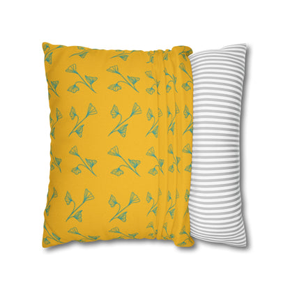 Yellow pillow with green leaf pattern and gray and white striped pillow on white background