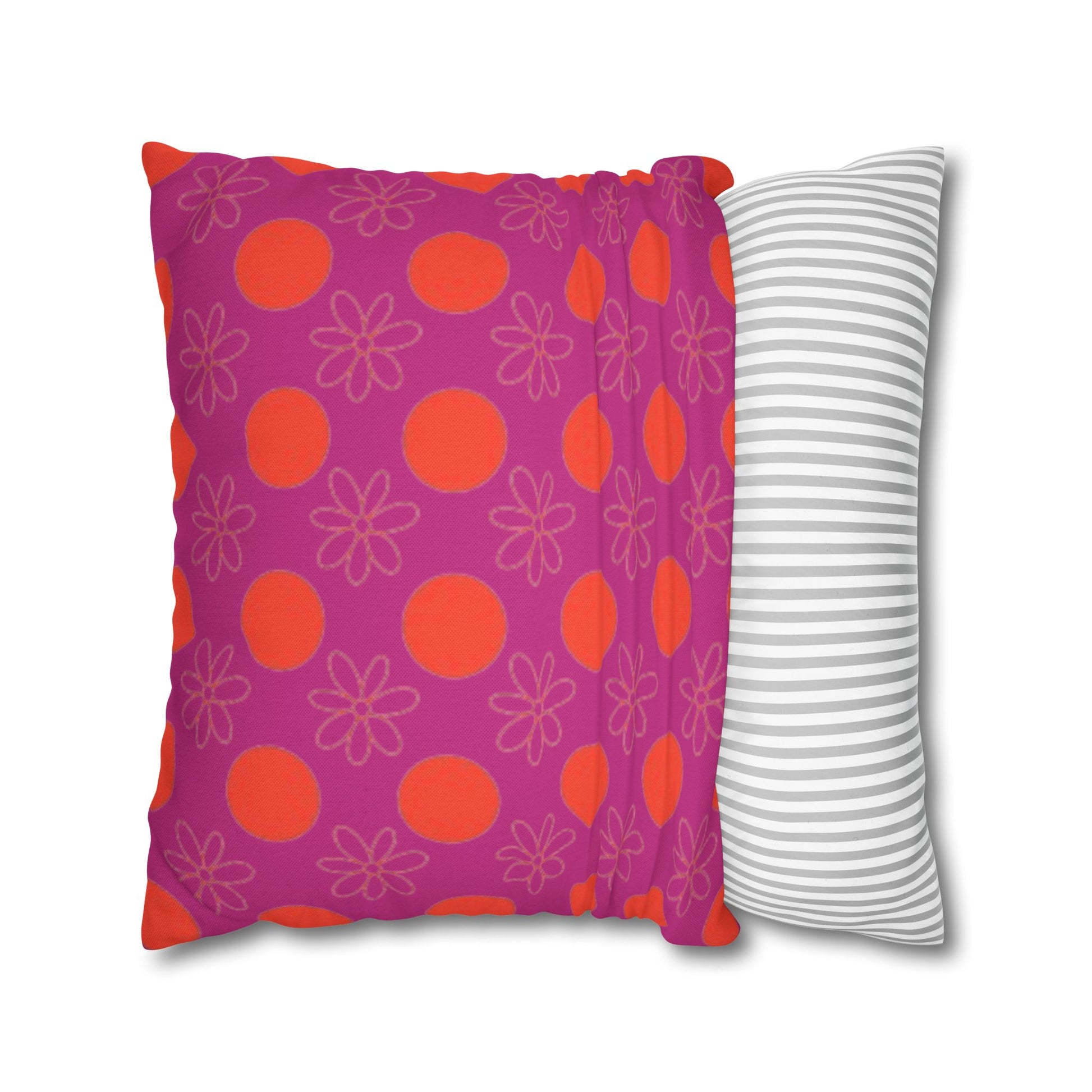  pillow with patterned covers, one pink with red circles and flowers, the other white with gray stripes, on a white background.