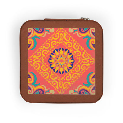 Hand holding a small square travel jewelry case with a colorful pattern on a white background