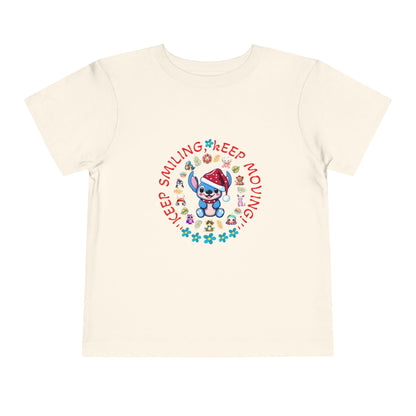 Toddler t-shirt with a cute dog illustration and motivational quote "Keep Smiling Keep Moving" printed in the center.