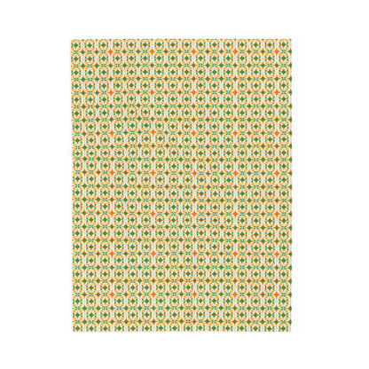 A folded velveteen plush blanket with a geometric pattern in green, yellow, and red colors.