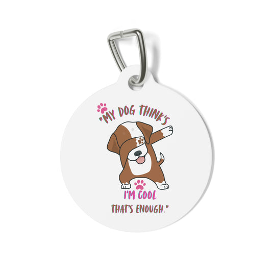 Round metal pet tag with custom engraving, attached to a collar

