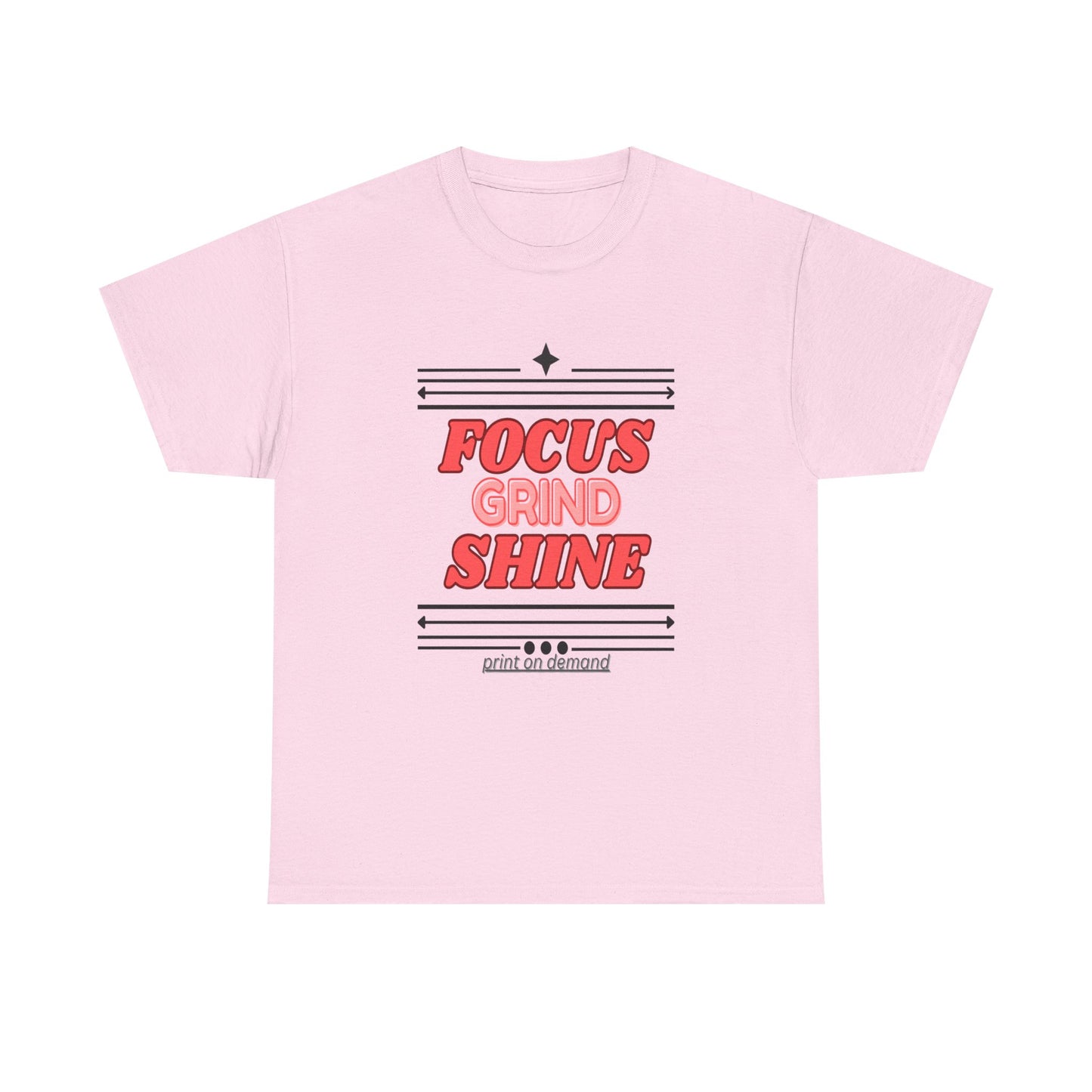 A light pink unisex heavy cotton tee with the text 'FOCUS GRIND SHINE' printed on the front.