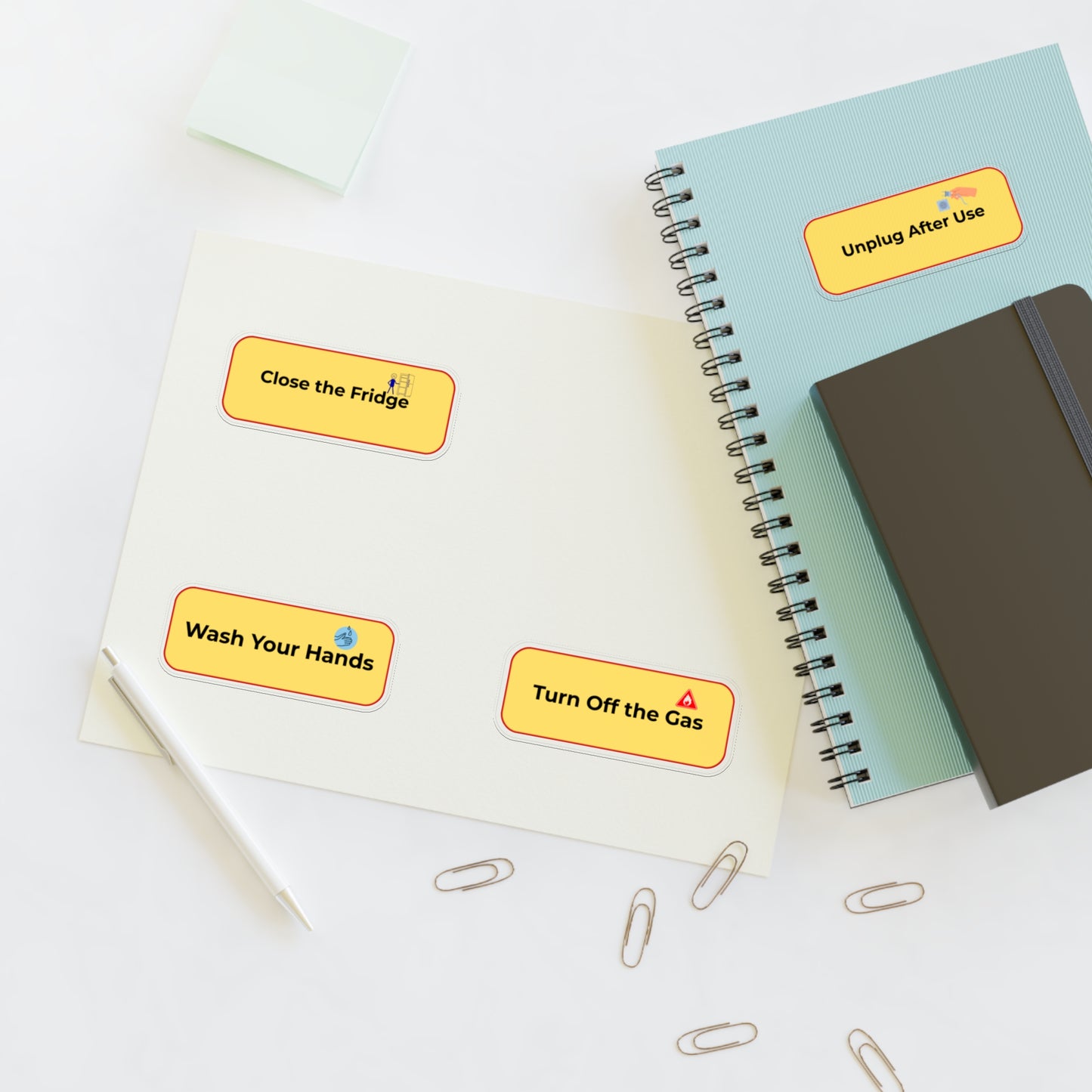 Notebooks with safety reminder stickers on a white surface