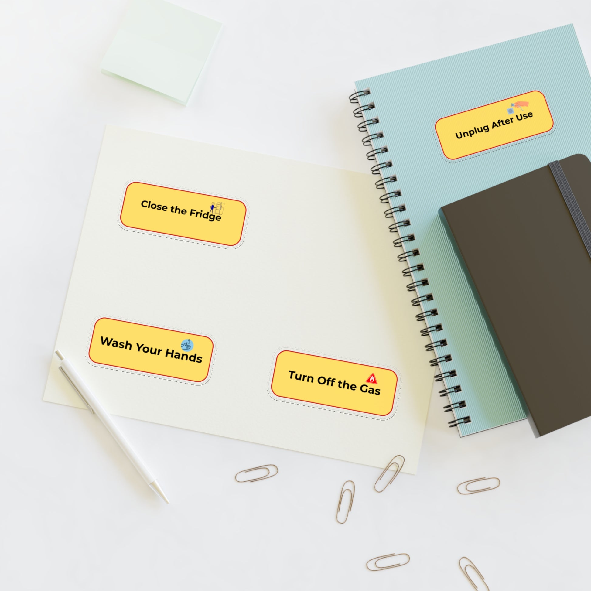 Notebooks with safety reminder stickers on a white surface