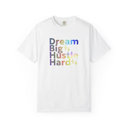 White t-shirt with colorful text 'Dream Big Hustle Hard' on a white background