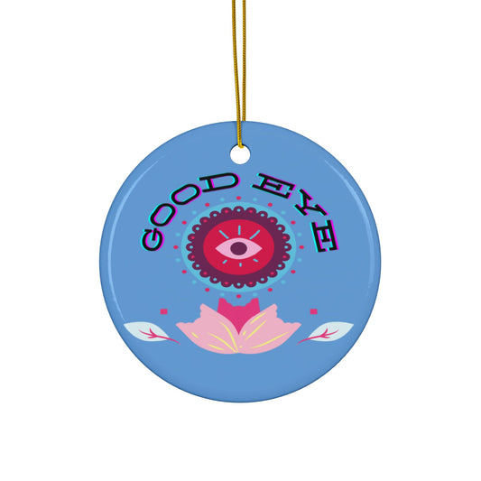 A blue ceramic ornament with a colorful floral design and the text 'GOOD EYE' at the top.