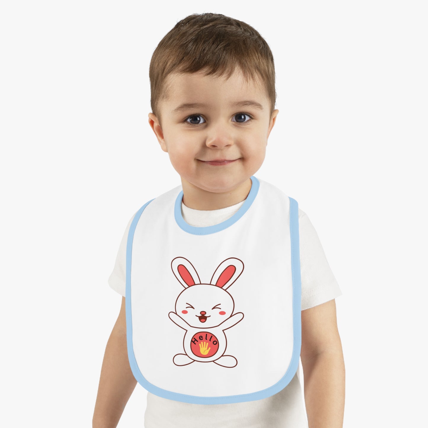 Child wearing a bib with a cartoon rabbit design on a plain background