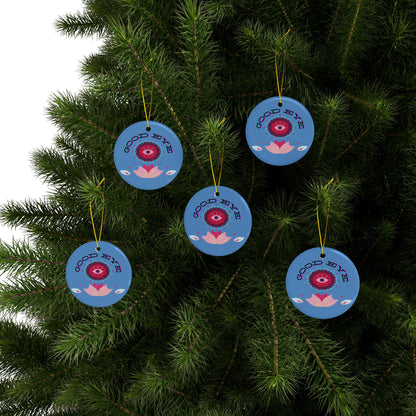 Blue decorative ornaments with red eye design hanging on a tree.