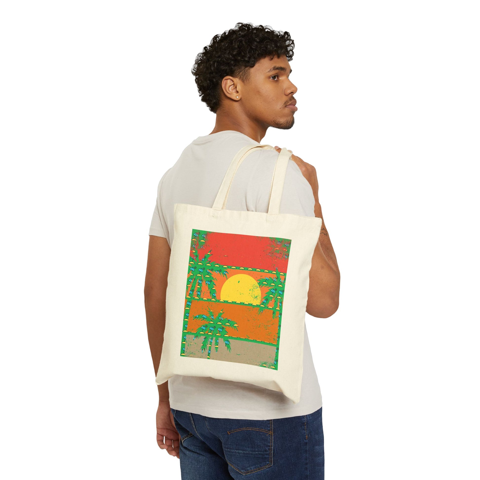 Person carrying a tote bag with a colorful design of a sunset and palm trees.