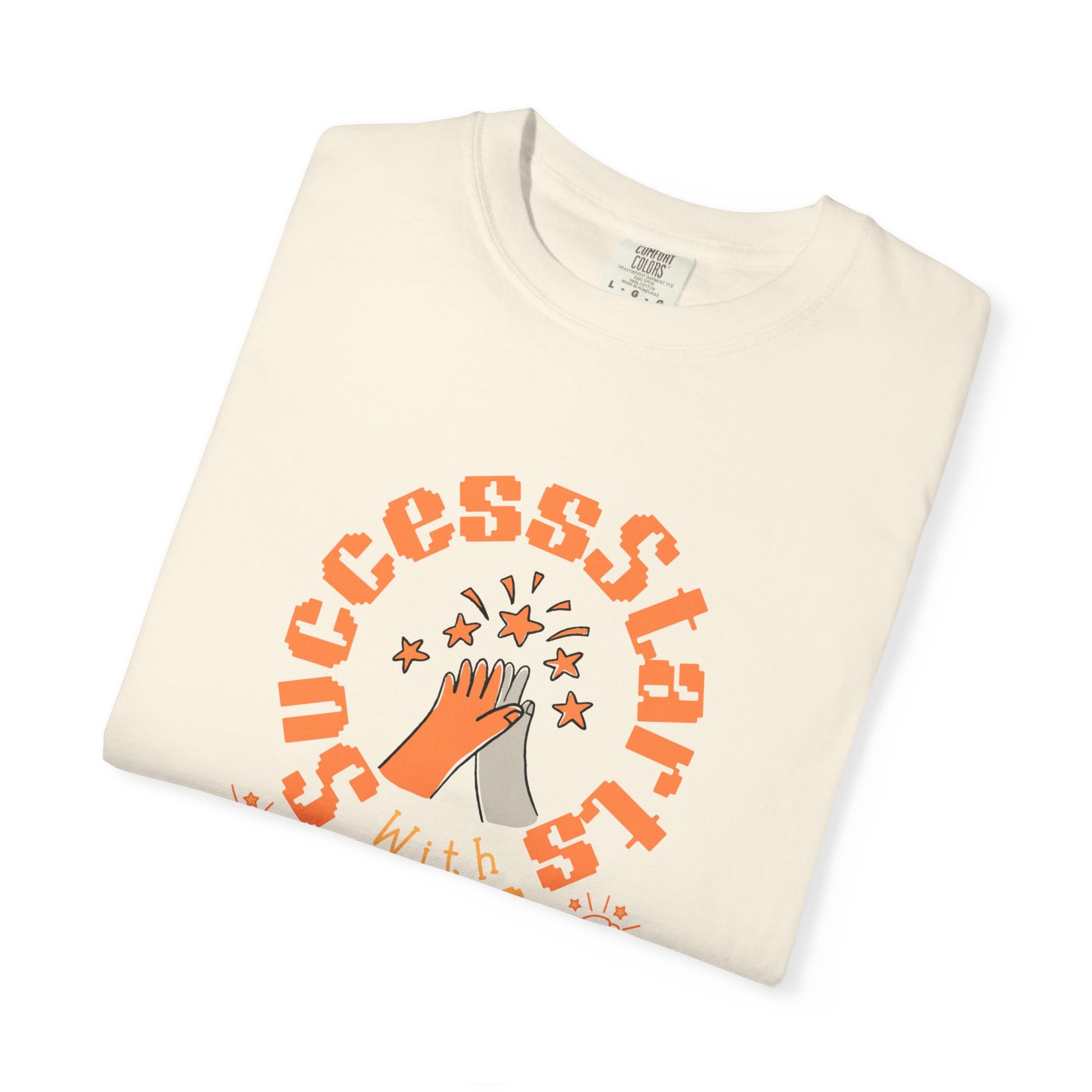 Folded cream-colored sweatshirt with orange text and graphics on a white background