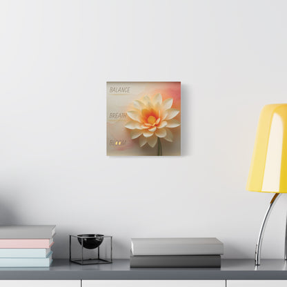 Decorative wall art of a flower on a white wall above a table with a lamp and books.