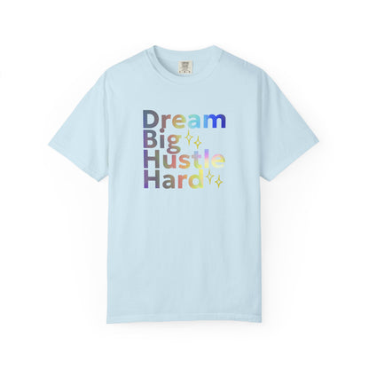 Light blue(chambray) t-shirt with motivational text 'Dream Big Hustle Hard' on a white background