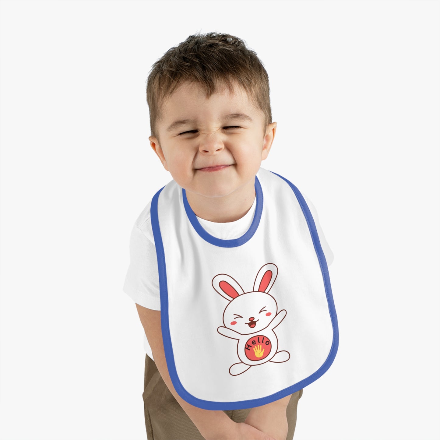 Child wearing a bib with a cartoon rabbit design on a plain background
