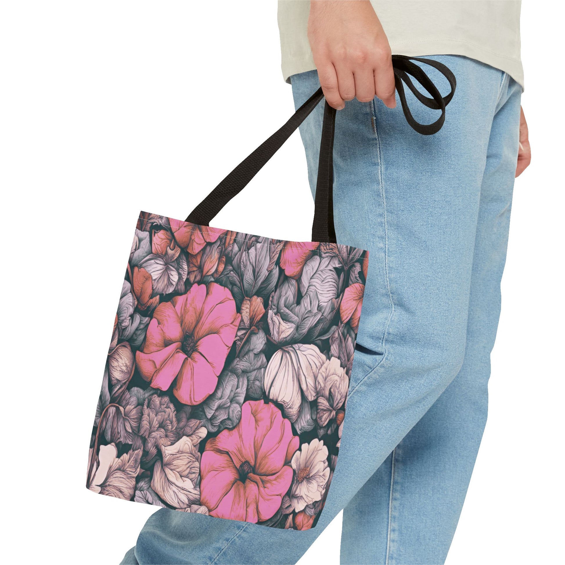 Person holding a tote bag with floral design on a white background