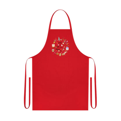 Cotton kitchen apron with "Bake it till you make it" text and circular illustrations of cake, biscuit, cone, and baking utensils.

