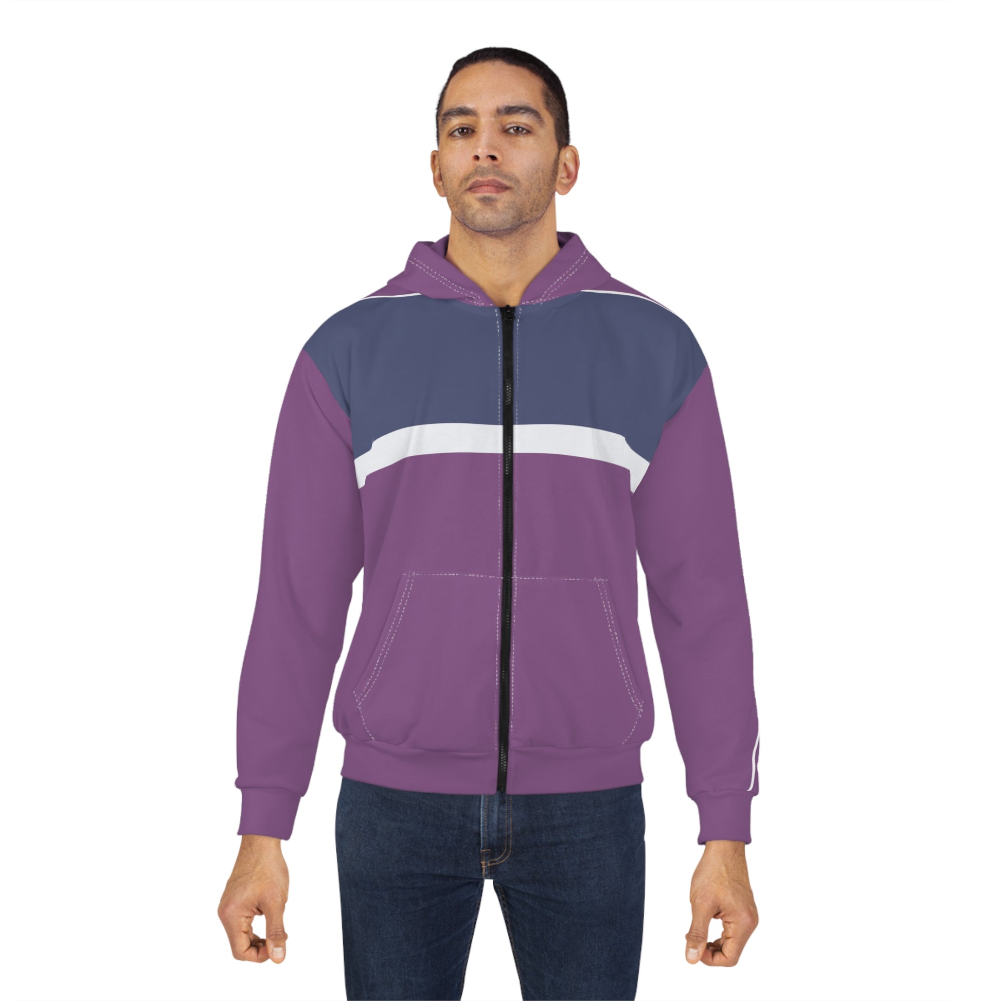 A man wearing a purple and navy blue colorblock zip-up hoodie with a white chest stripe, paired with dark blue jeans, against a plain white background.