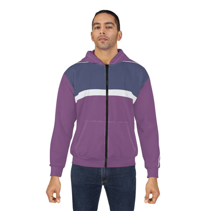A man wearing a purple and navy blue colorblock zip-up hoodie with a white chest stripe, paired with dark blue jeans, against a plain white background.