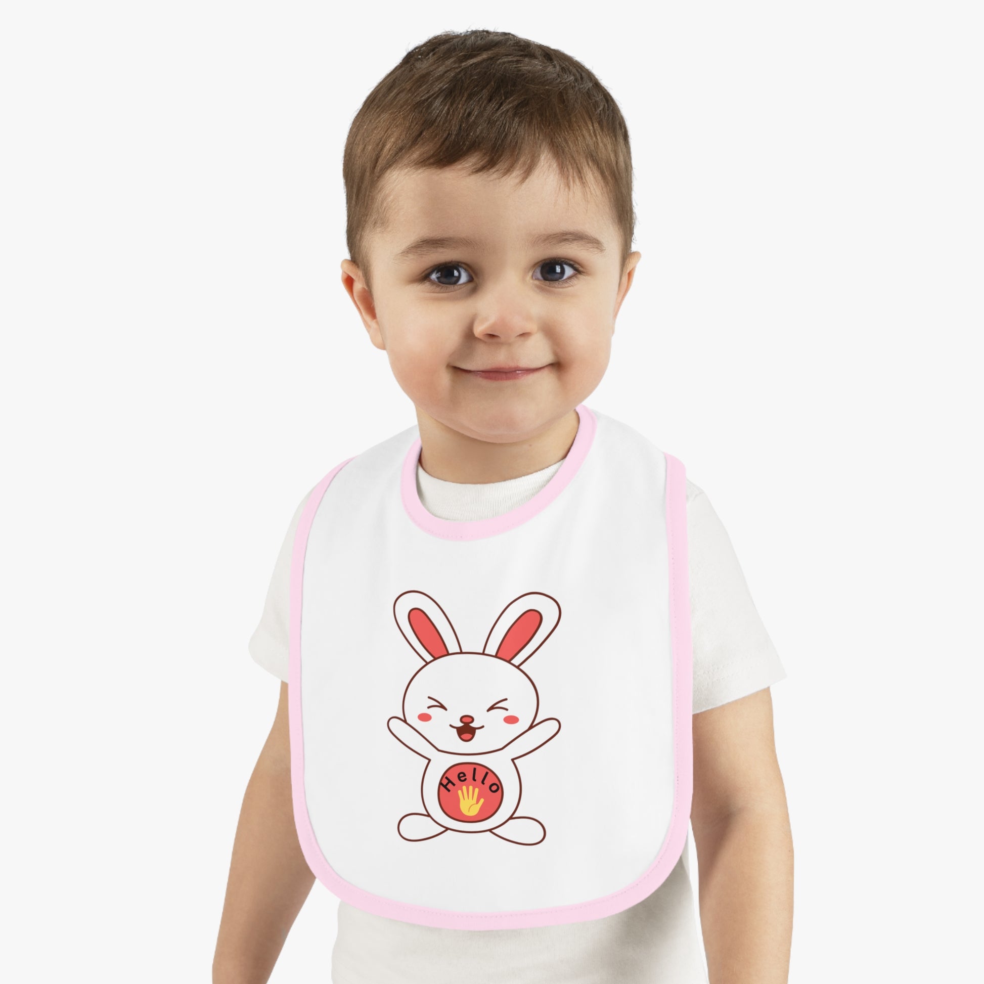 Child wearing a bib with a cartoon rabbit design on a plain background