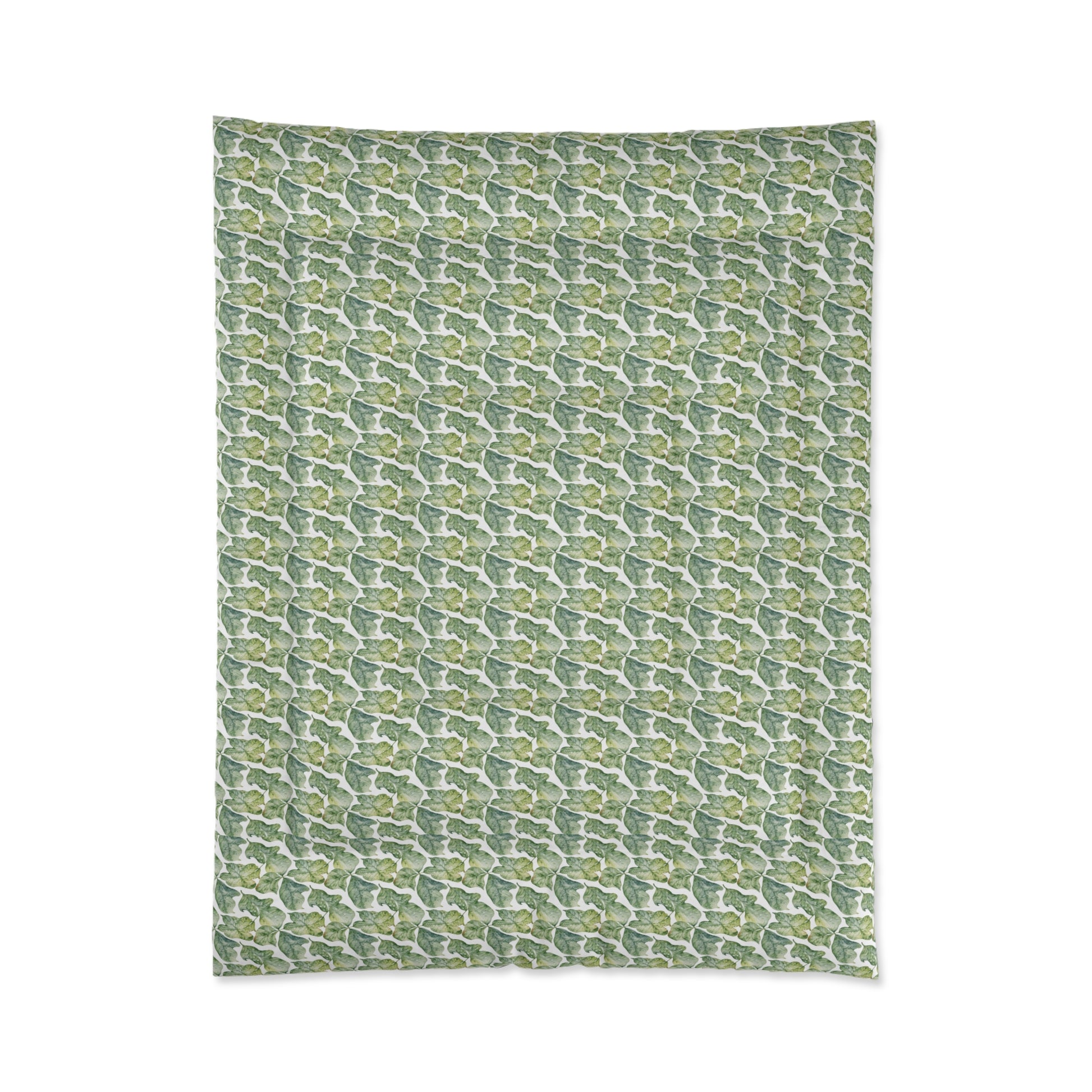 A comforter with a geometric pattern in shades of green and white, displayed against a white background.