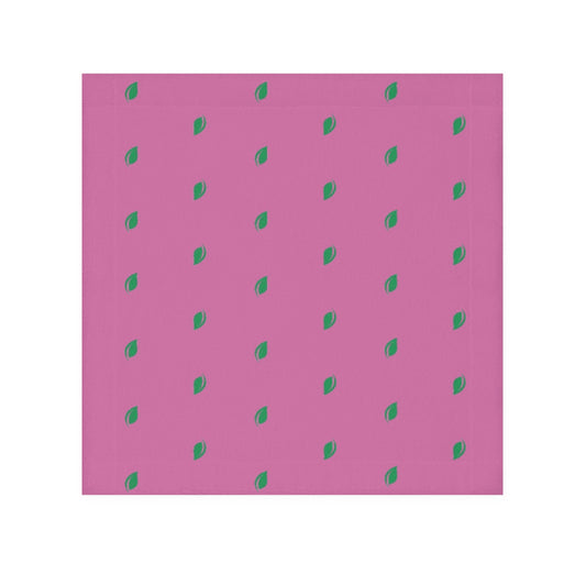 A pink face towel with a pattern of small, green leaf-like shapes distributed evenly over the surface.

