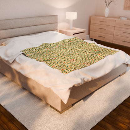 Bed with a green patterned blanket in a bedroom setting