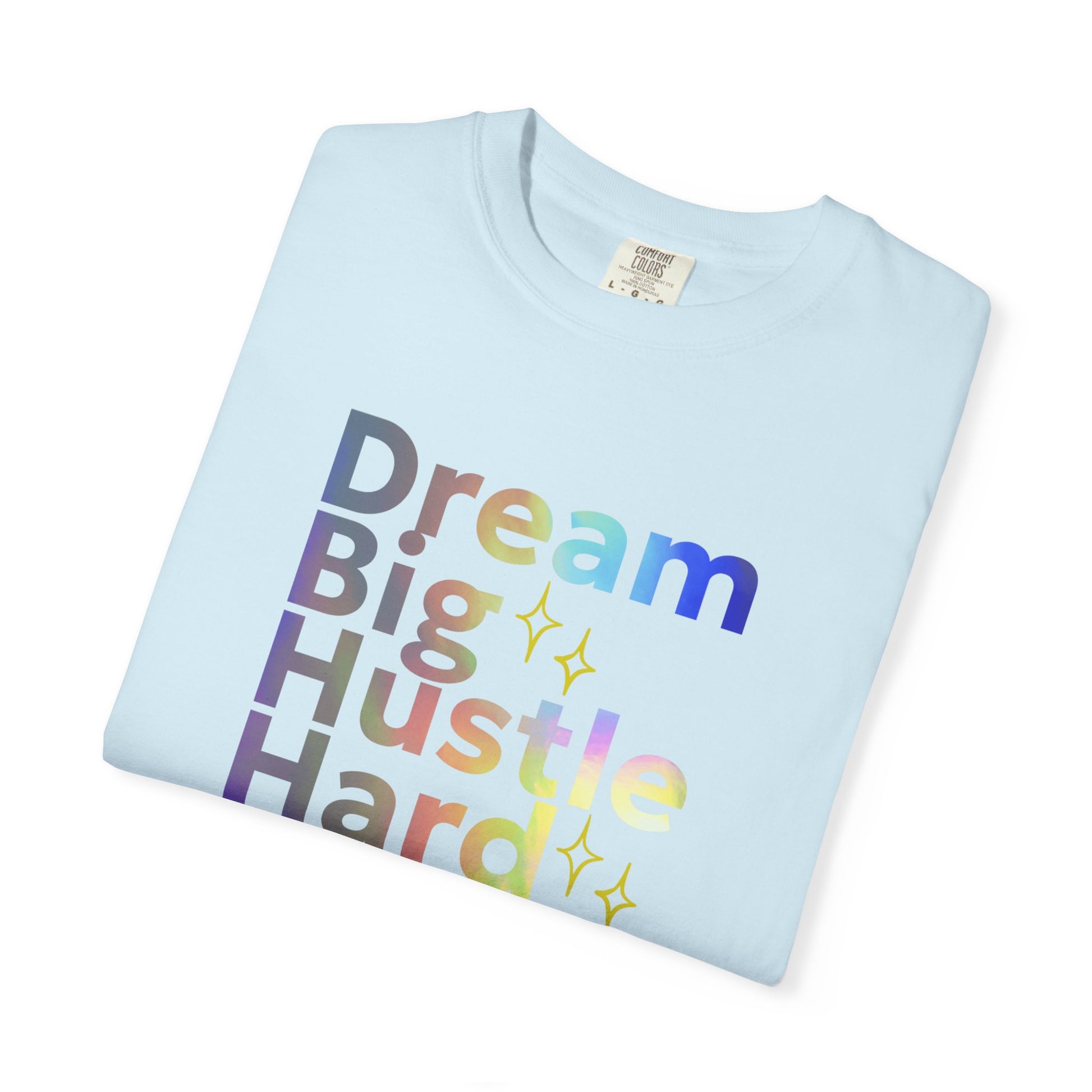 Light blue t-shirt with 'Dream Big Hustle Hard' text in colorful letters on a white background