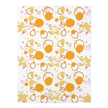 A baby swaddle blanket with an orange and white pattern, possibly with stars and other geometric shapes.