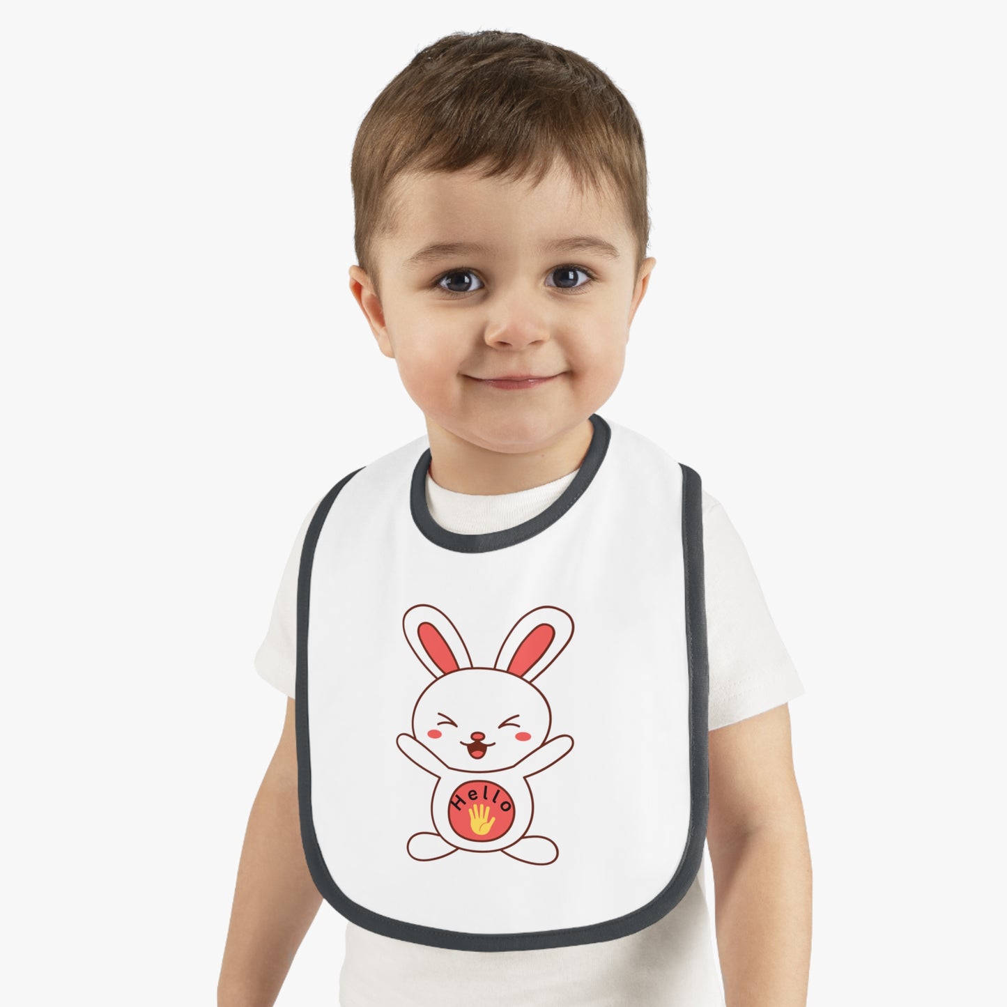 Child wearing a white bib with a cartoon rabbit design on a plain background