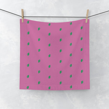 Pink fabric with green dot pattern hanging on a line.