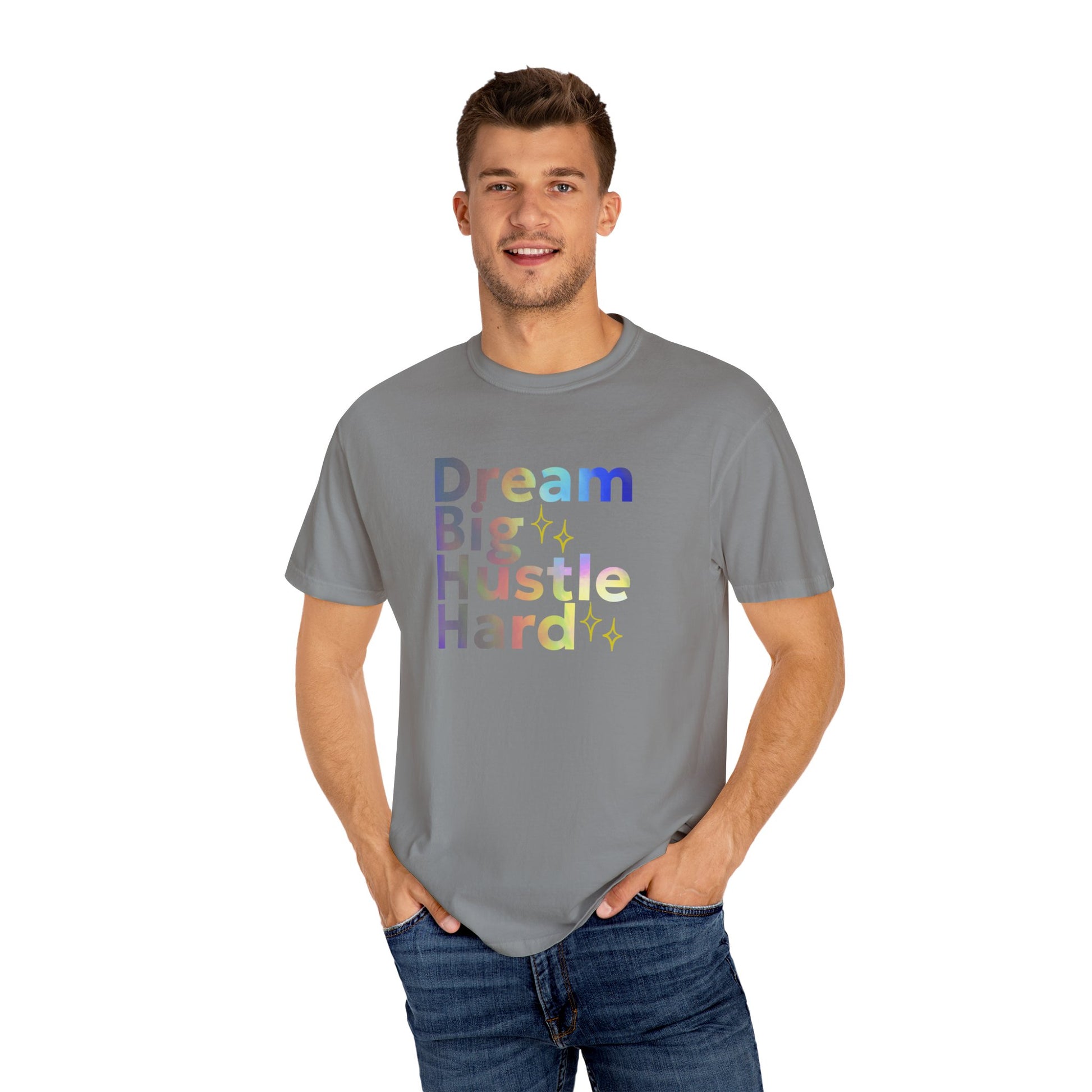 Man wearing a gray t-shirt with colorful text 'Dream Big Hustle Hard' on a white background