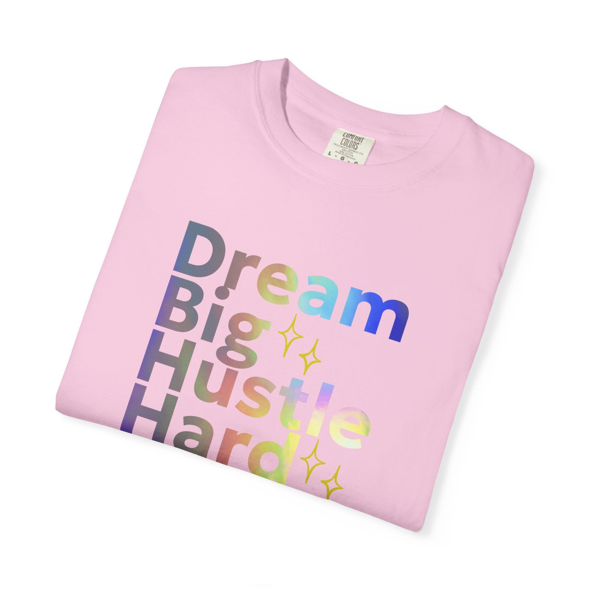 Pink t-shirt with 'Dream Big Hustle Hard' text on a white background
