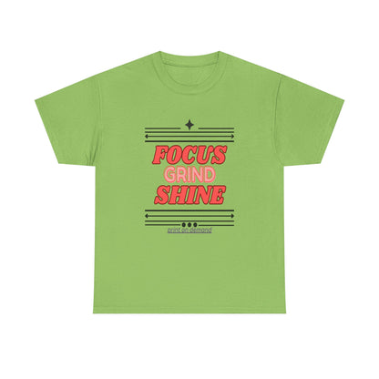 A lime unisex heavy cotton tee with the text 'FOCUS GRIND SHINE' printed on the front.