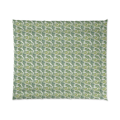 A comforter with a geometric pattern in shades of green and white, displayed against a white background.