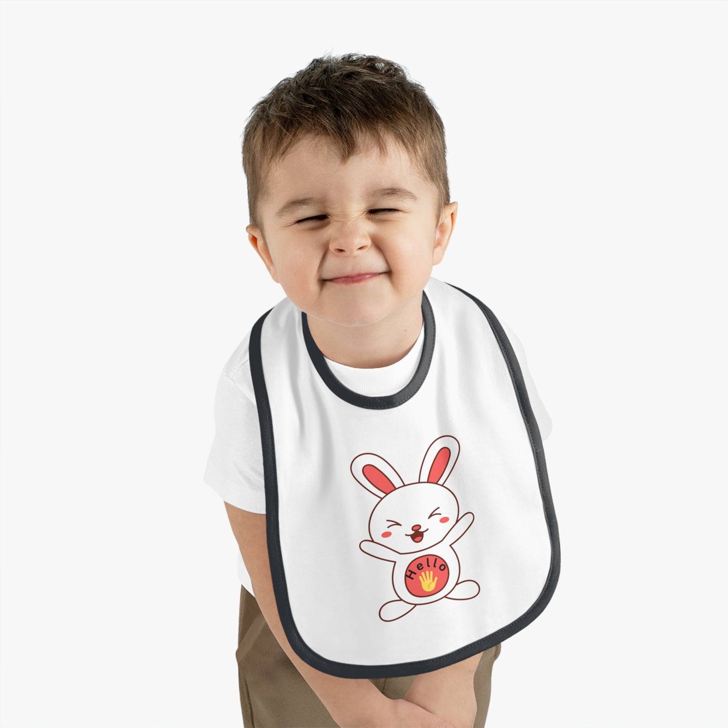 Child wearing a bib with a cartoon bunny design on a white background