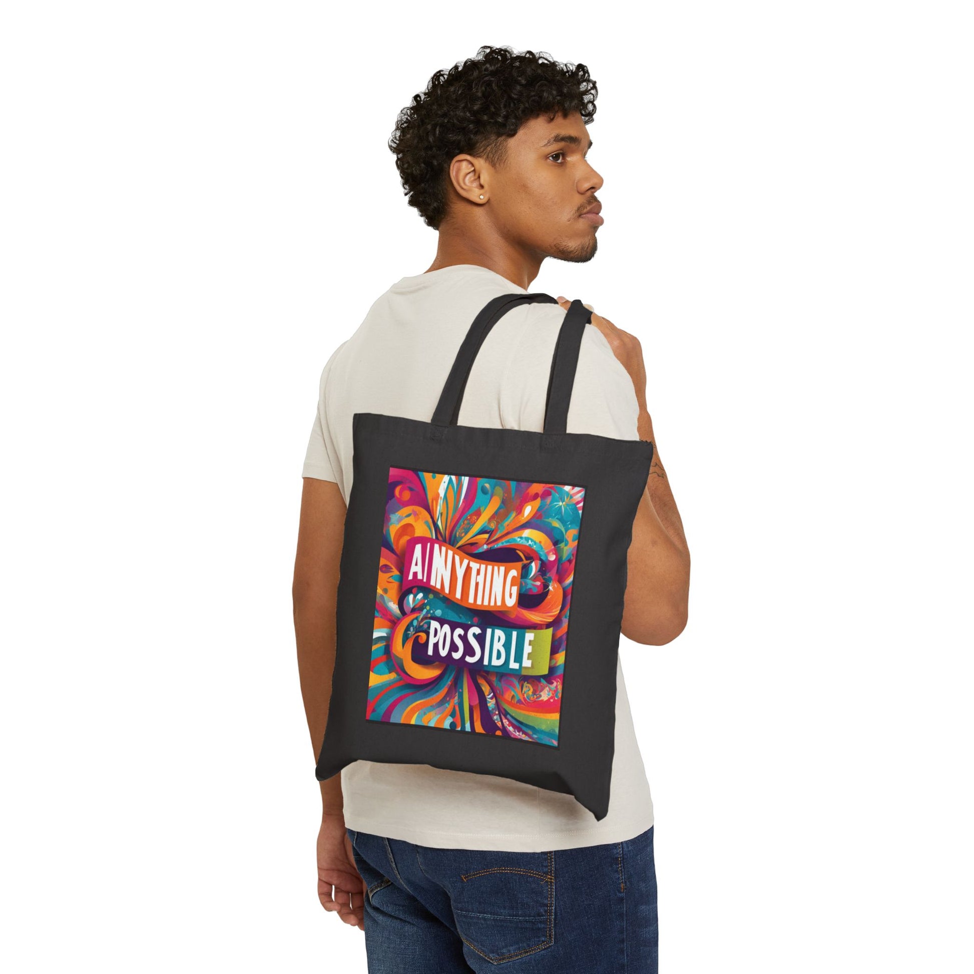 Person carrying a black tote bag with a colorful design and text.